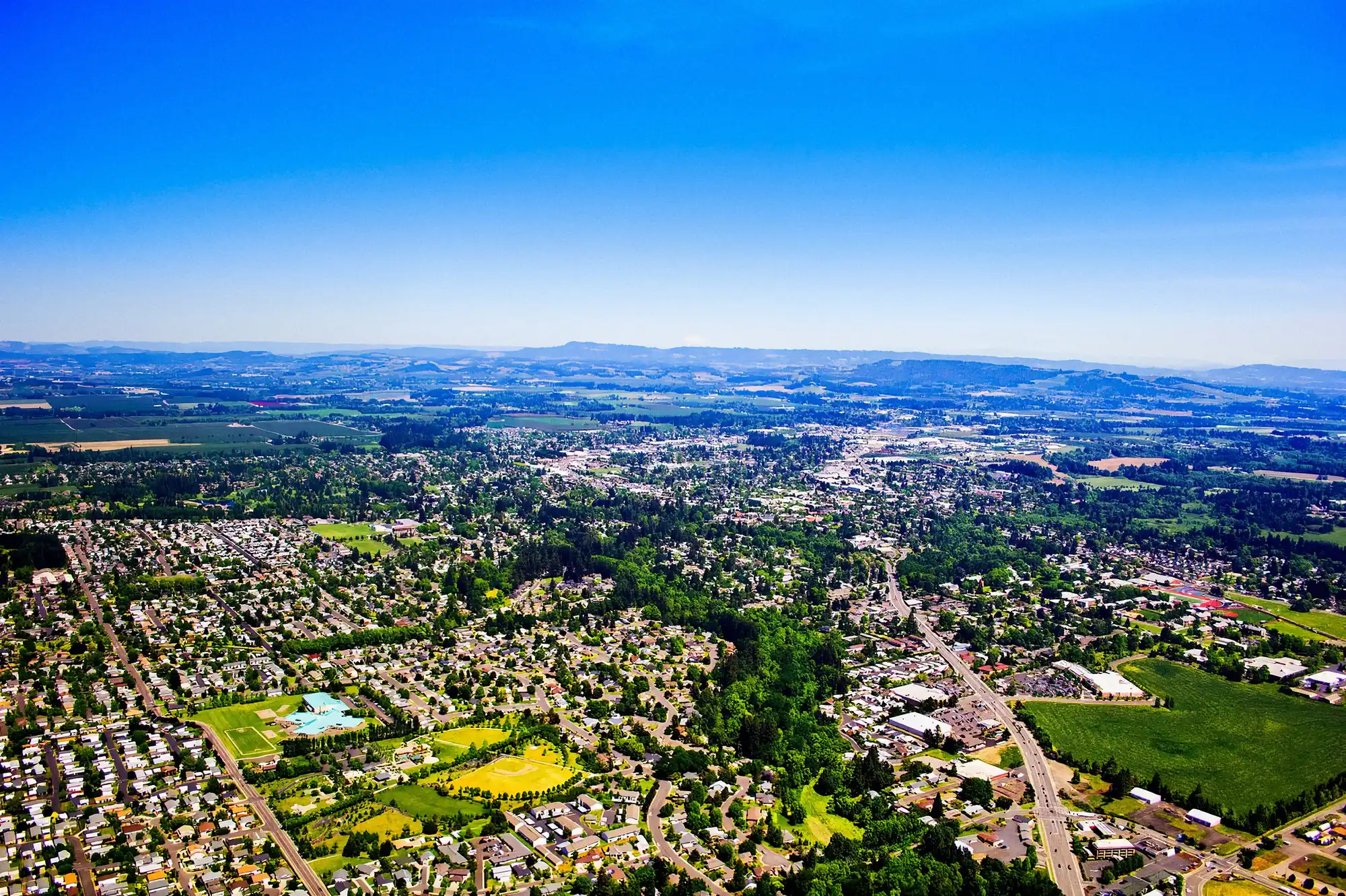 McMinnville, Oregon and the Yamhill County farmland from the air, the Coast Range beyond